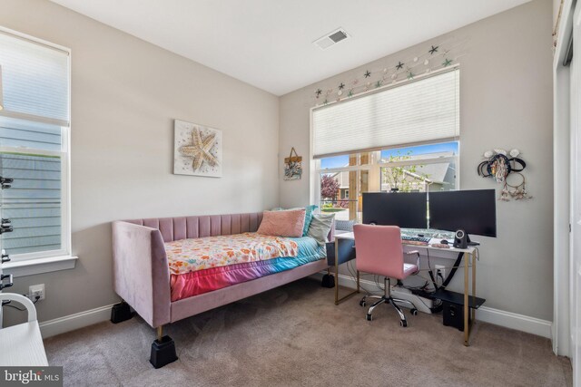 bedroom with baseboards, carpet, and visible vents