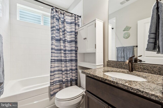 full bath with visible vents, shower / bathtub combination with curtain, toilet, and vanity