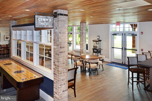 interior space featuring visible vents, hardwood / wood-style floors, wooden ceiling, and french doors