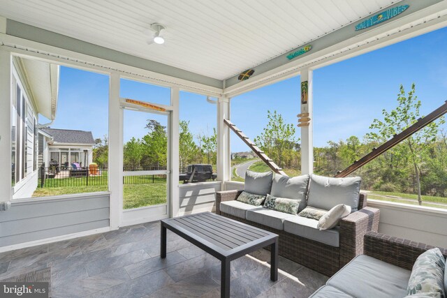 sunroom with an outdoor living space