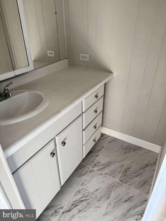 bathroom featuring marble finish floor and vanity