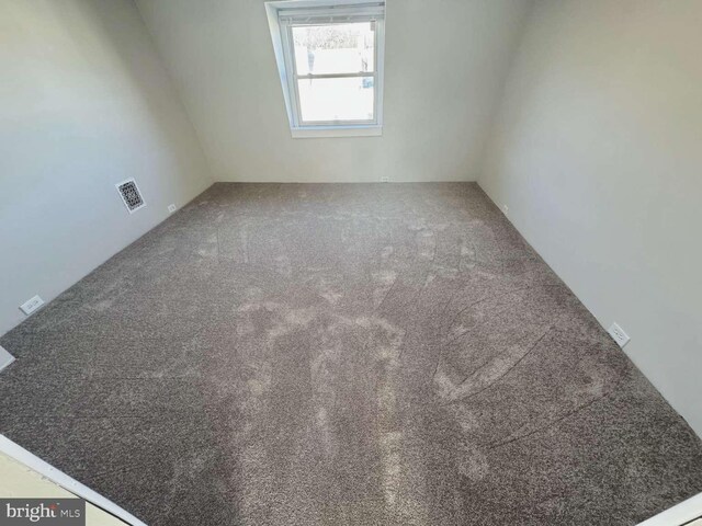 carpeted empty room with visible vents