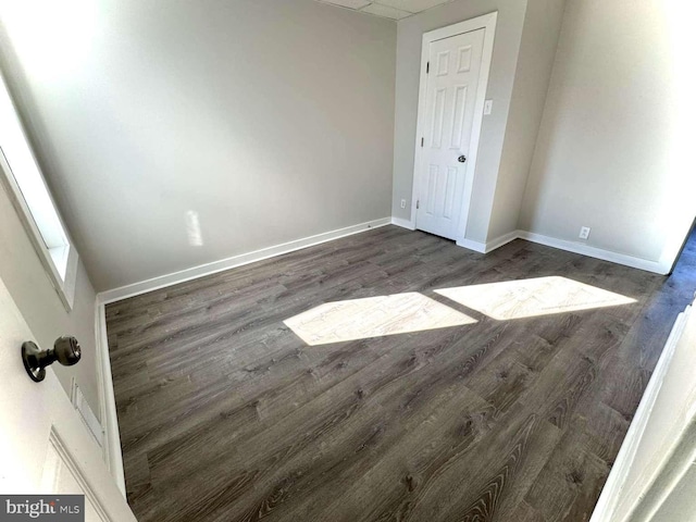 interior space featuring baseboards and wood finished floors