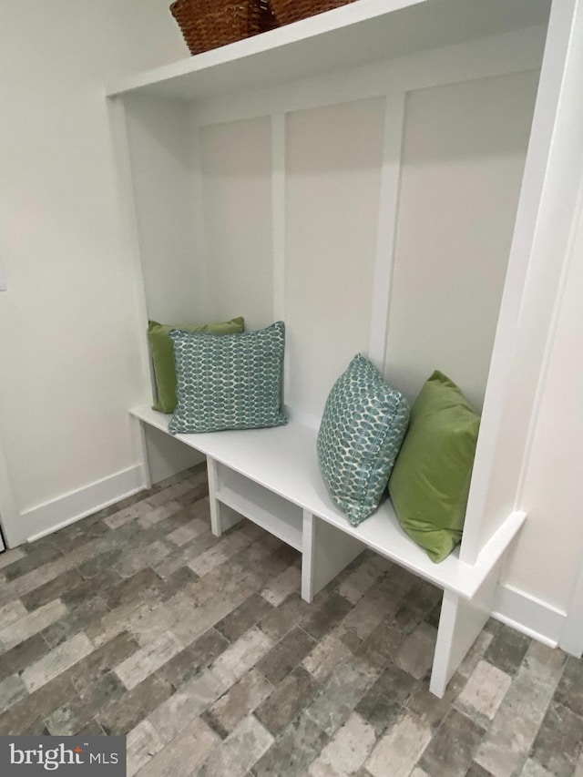 mudroom with wood finished floors and baseboards