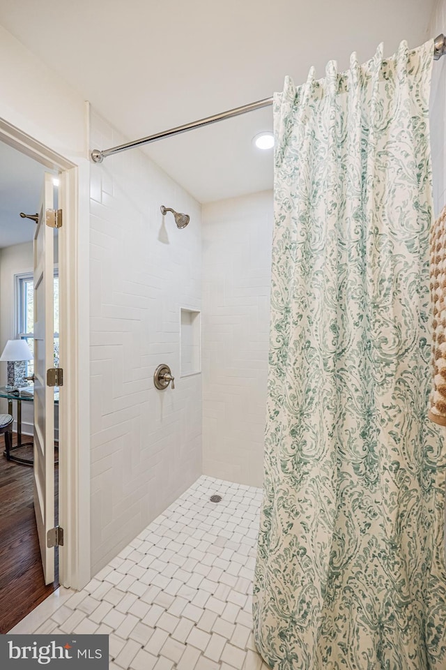 bathroom with tiled shower