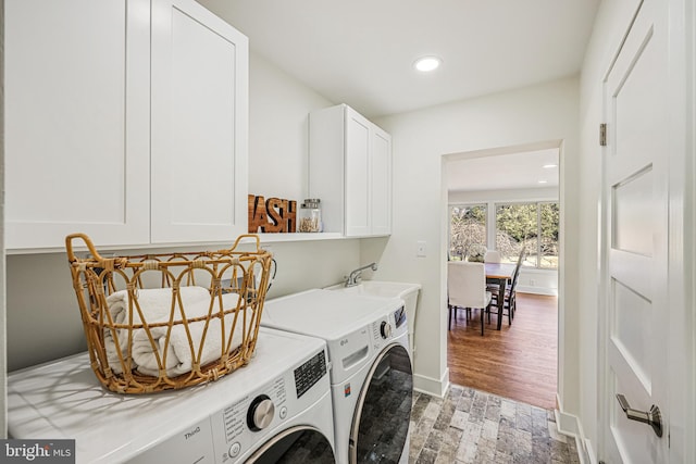 laundry room with baseboards, washing machine and dryer, cabinet space, and recessed lighting