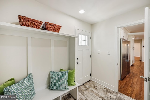 mudroom featuring baseboards, light wood-type flooring, and recessed lighting