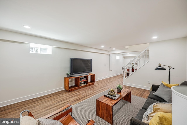 living area with stairway, recessed lighting, wood finished floors, and baseboards