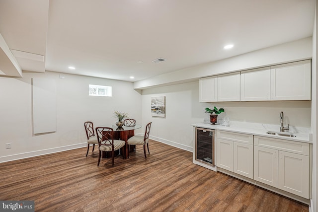 dining area with beverage cooler, dark wood-style flooring, recessed lighting, and baseboards