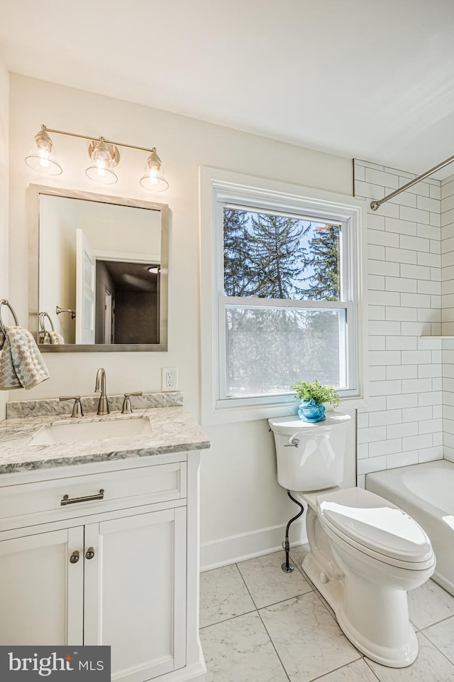 full bathroom featuring toilet, bathing tub / shower combination, baseboards, and vanity