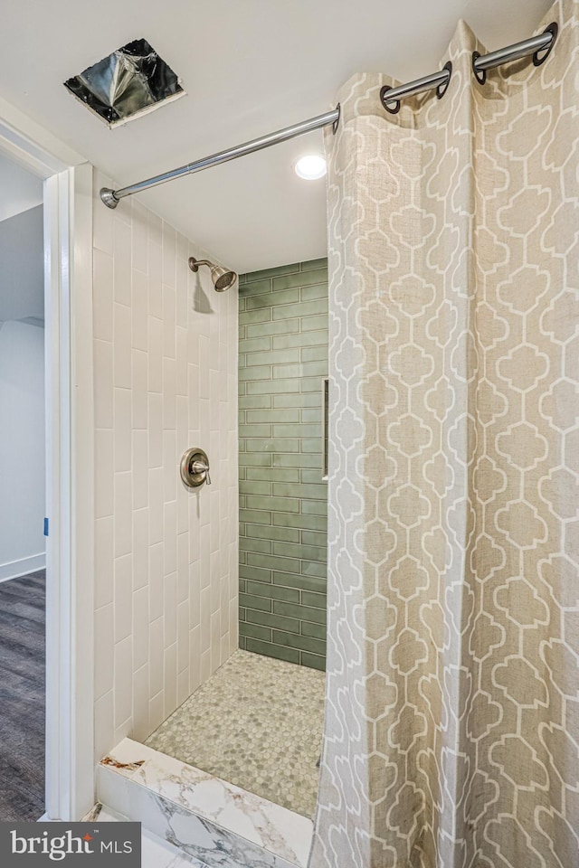 bathroom with a tile shower