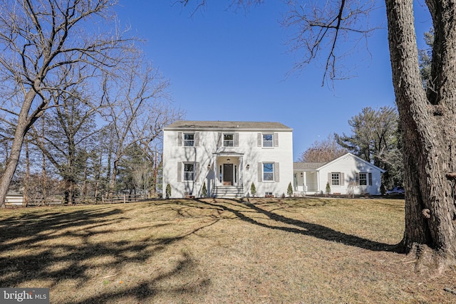 view of front of house with a front yard and fence