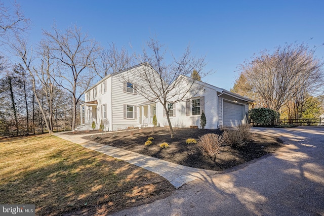 view of front of house featuring a garage, brick siding, and a front lawn