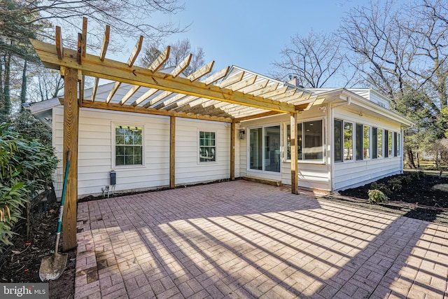 exterior space with a sunroom, a patio area, and a pergola