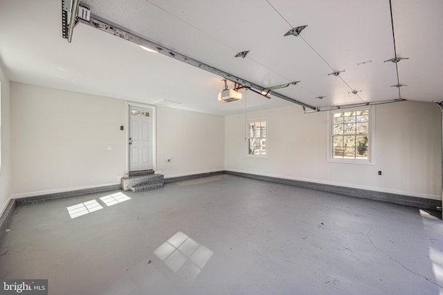 garage featuring baseboards and a garage door opener