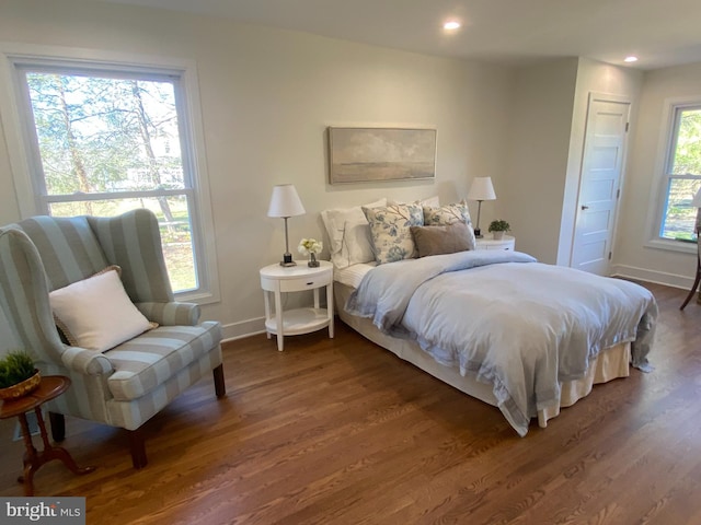 bedroom with baseboards, wood finished floors, and recessed lighting