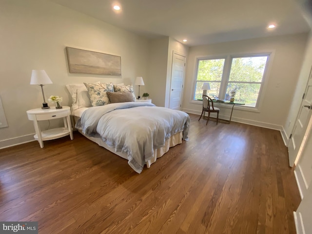 bedroom with dark wood-style floors, baseboards, and recessed lighting