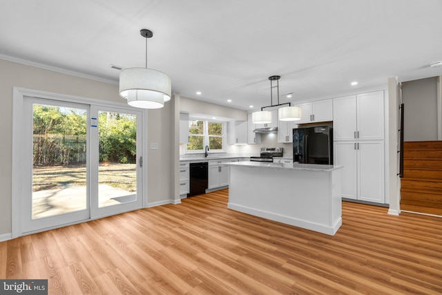 kitchen featuring black appliances, white cabinets, light wood-style floors, and under cabinet range hood