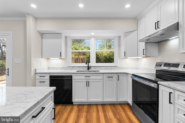 kitchen with under cabinet range hood, stainless steel electric stove, black dishwasher, white cabinets, and a sink