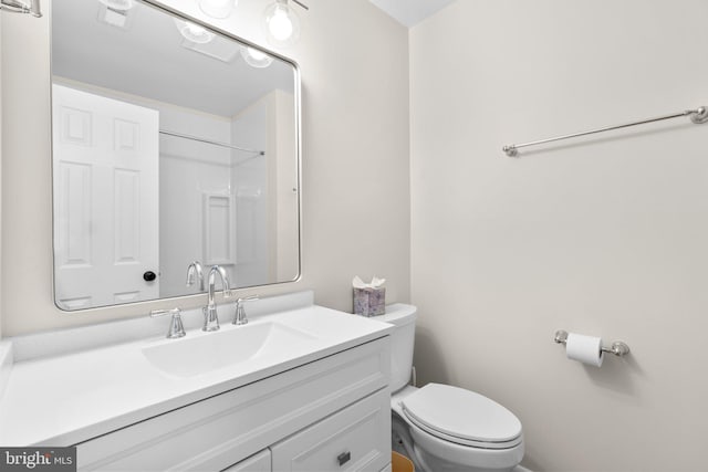 bathroom featuring vanity, toilet, and visible vents