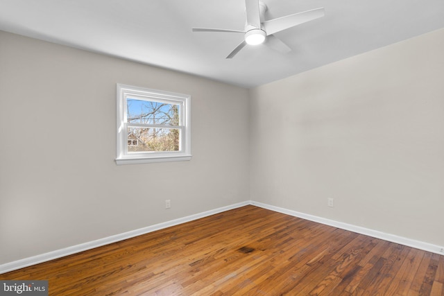 unfurnished room featuring baseboards, wood-type flooring, and ceiling fan