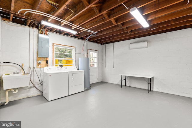 basement with washer and clothes dryer, water heater, electric panel, concrete block wall, and a sink