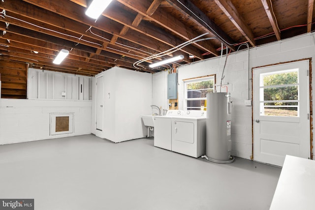 basement with washer and dryer, a sink, electric panel, electric water heater, and concrete block wall