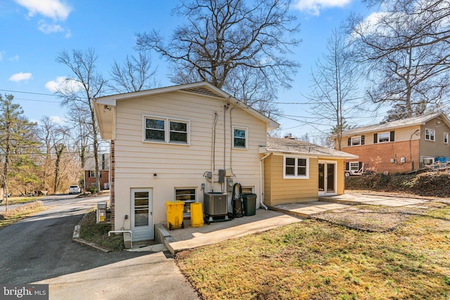 rear view of house featuring a patio area and central air condition unit