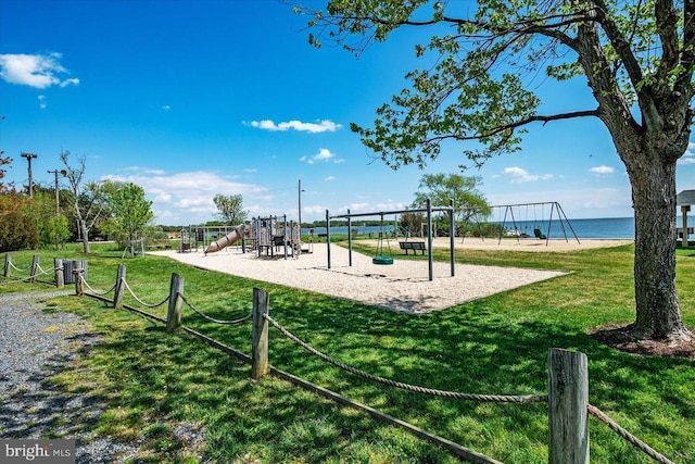 view of home's community with playground community and a yard