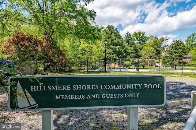 community sign featuring fence