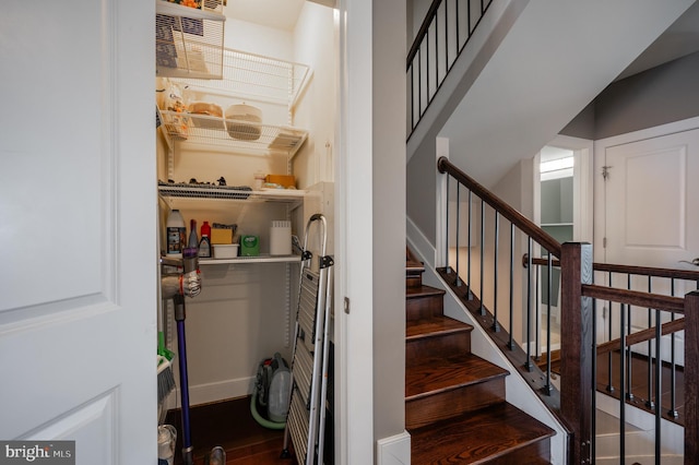 stairway with baseboards and wood finished floors