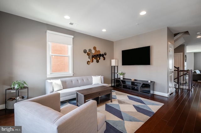 living area with recessed lighting, wood finished floors, and baseboards