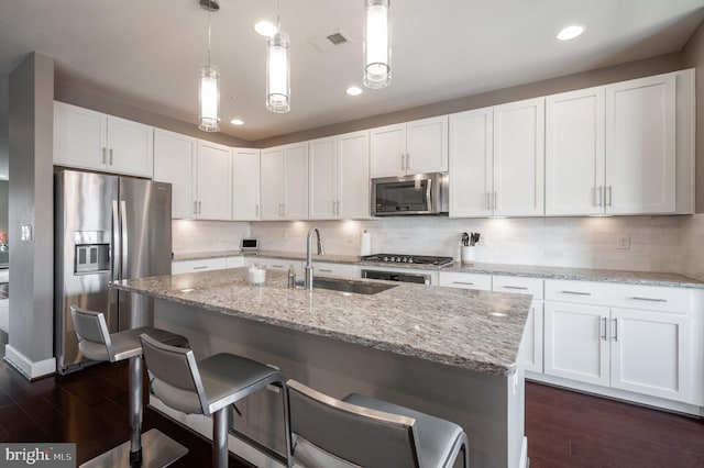 kitchen featuring visible vents, a sink, dark wood-type flooring, white cabinets, and appliances with stainless steel finishes