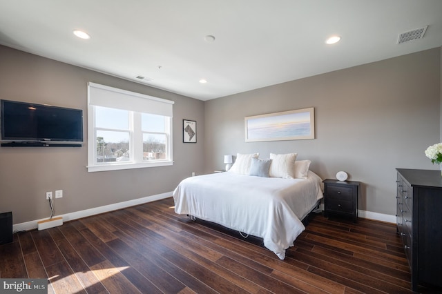 bedroom featuring dark wood finished floors, baseboards, and visible vents