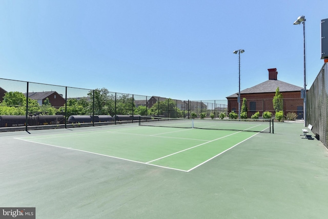 view of sport court featuring fence