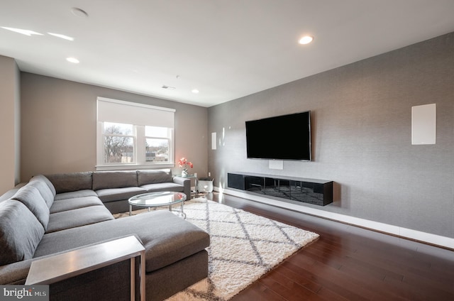 living room with dark wood finished floors and recessed lighting