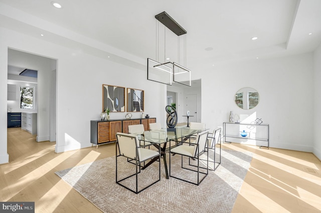 dining space with light wood finished floors and recessed lighting