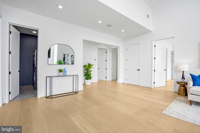 living room with light wood-style floors, recessed lighting, and baseboards