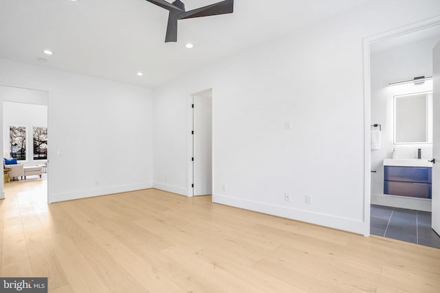 interior space with light wood-style flooring, baseboards, ceiling fan, and recessed lighting