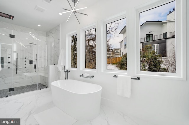 full bathroom featuring a freestanding bath, marble finish floor, a marble finish shower, and recessed lighting