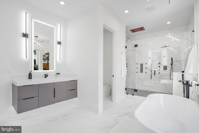 bathroom with a freestanding bath, marble finish floor, a marble finish shower, and recessed lighting