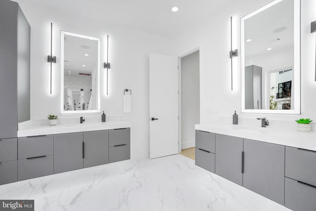 full bathroom featuring two vanities, a sink, and recessed lighting