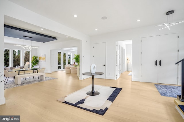 exercise room with light wood-type flooring and recessed lighting