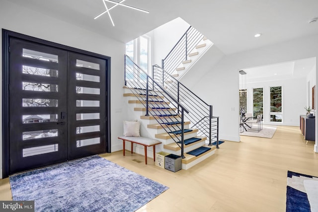 entrance foyer with baseboards, stairway, wood finished floors, and recessed lighting