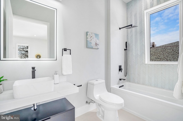 bathroom with tub / shower combination, vanity, toilet, and a healthy amount of sunlight