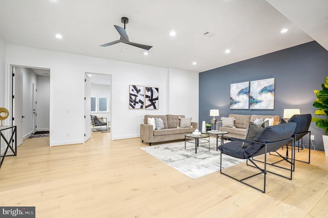 living area featuring light wood-type flooring, baseboards, a ceiling fan, and recessed lighting