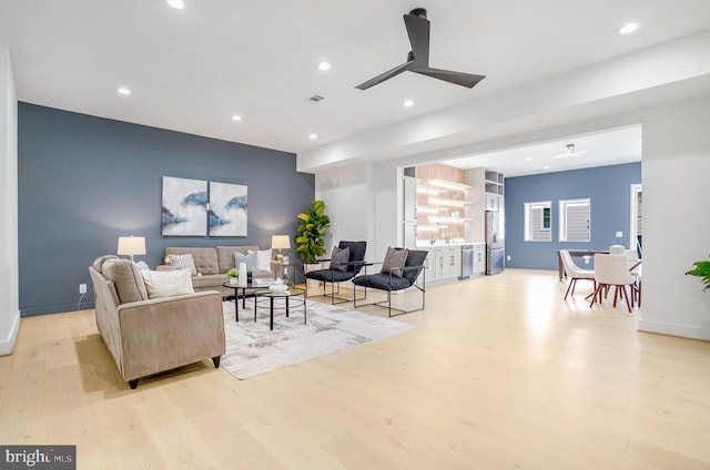 living area with light wood finished floors, baseboards, a ceiling fan, and recessed lighting