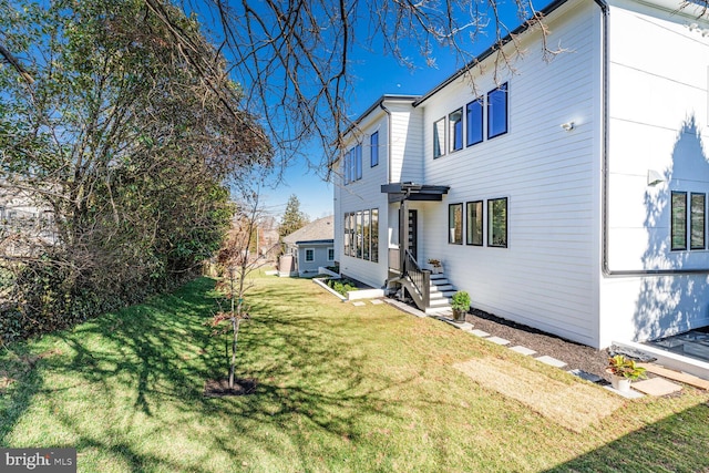 view of side of home featuring a yard