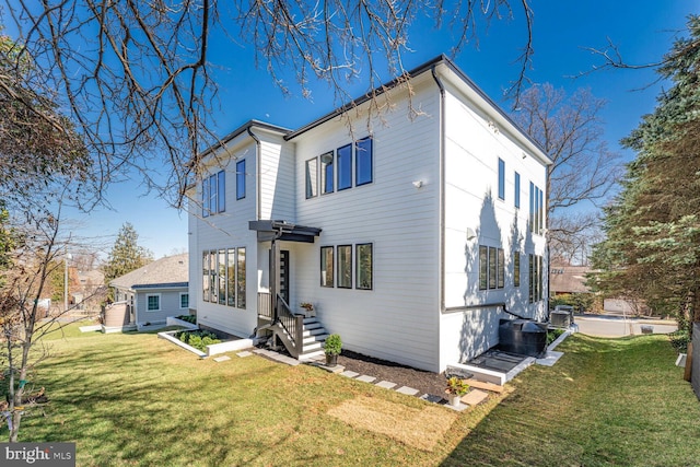 exterior space with a front yard and central AC