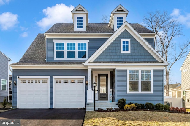 view of front of property with aphalt driveway and a shingled roof